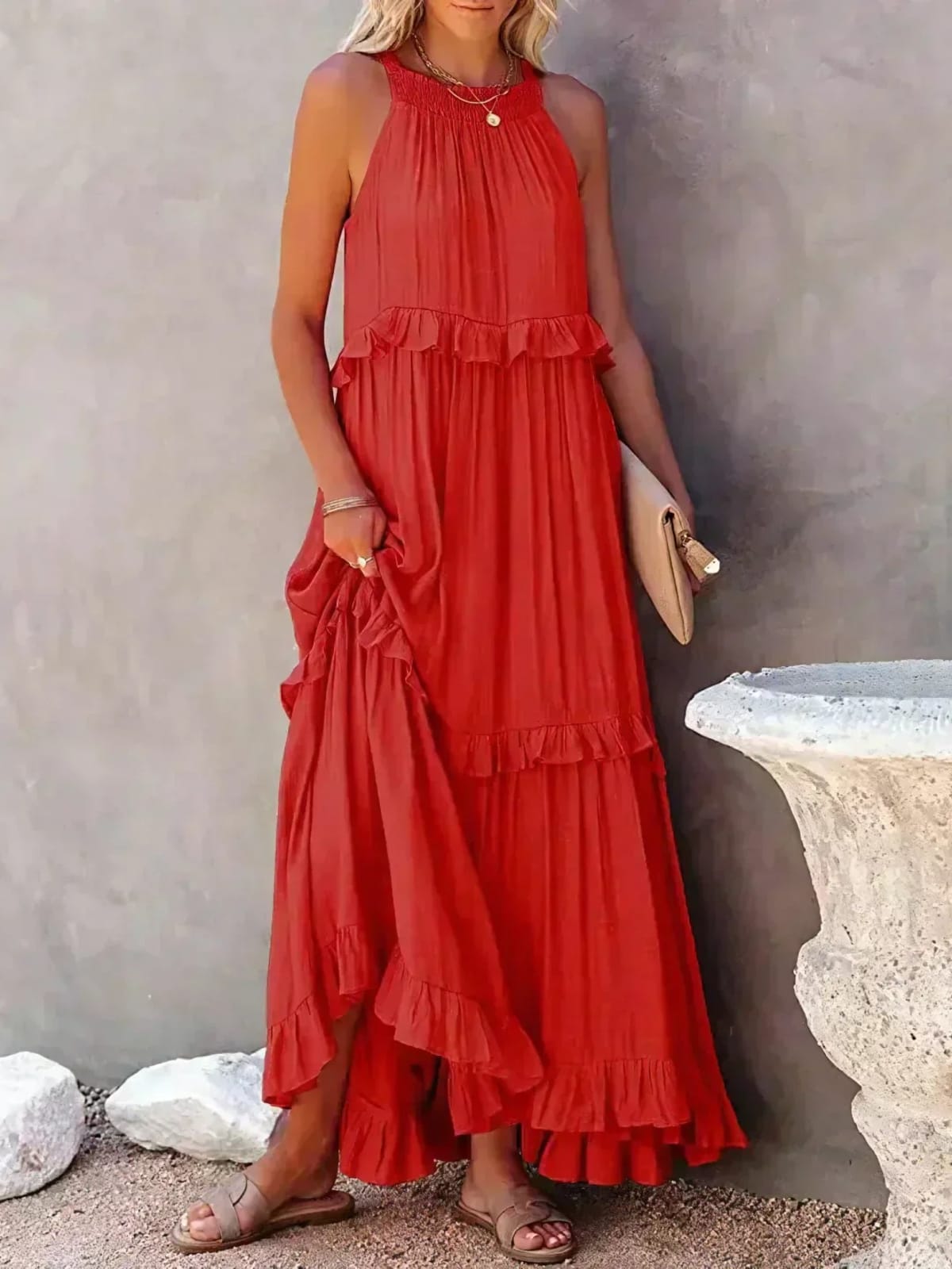 Sleeveless dress with ruffles, flowing fit, suitable for various occasions.