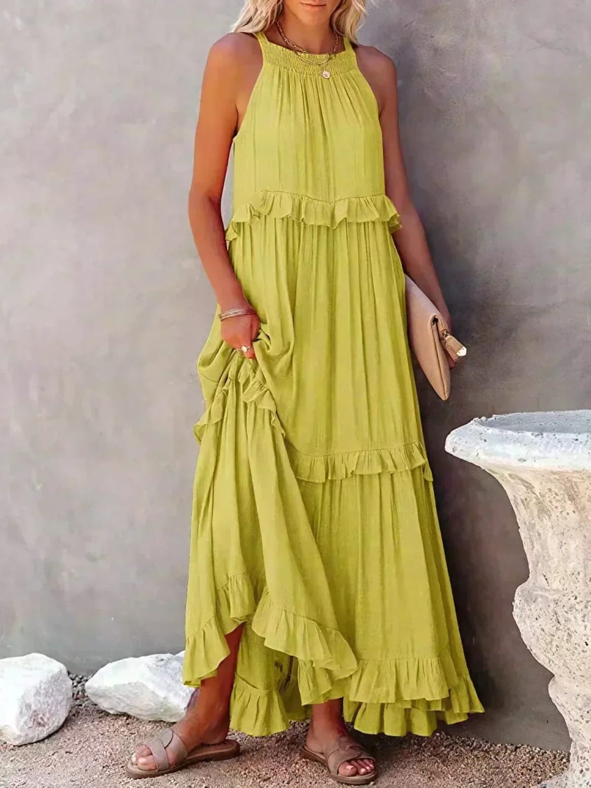 Sleeveless dress with ruffles, flowing fit, suitable for various occasions.