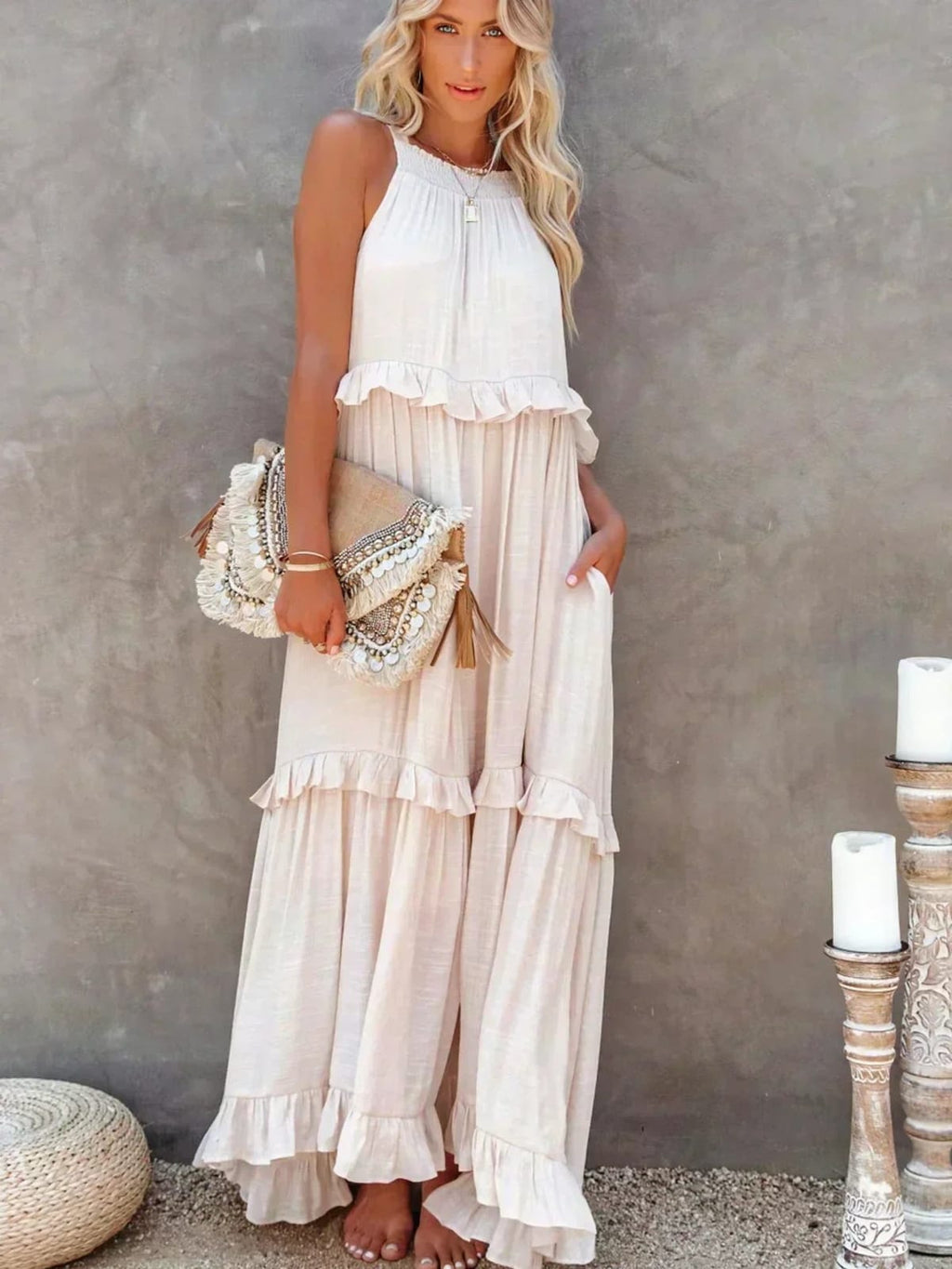 Sleeveless dress with ruffles, flowing fit, suitable for various occasions.