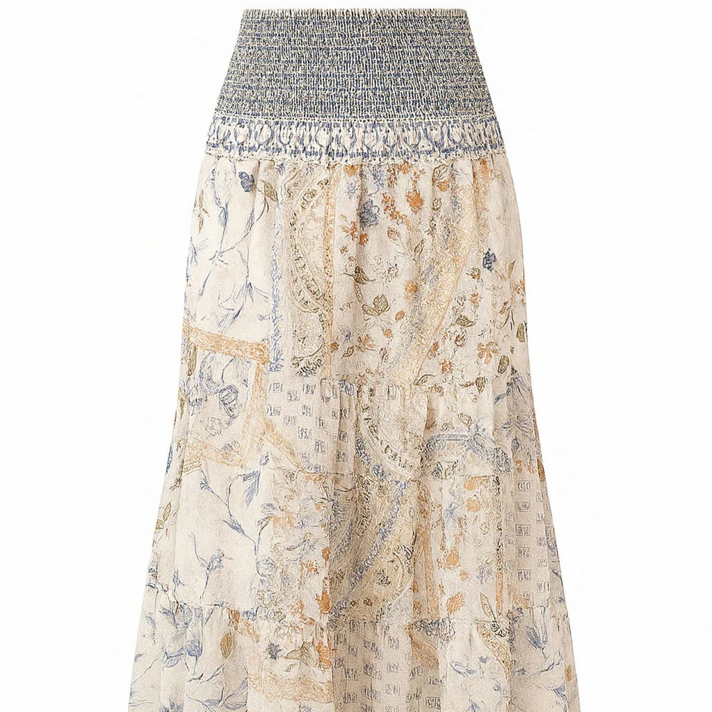 Cream-colored tiered maxi skirt with bohemian print and smocked waist.