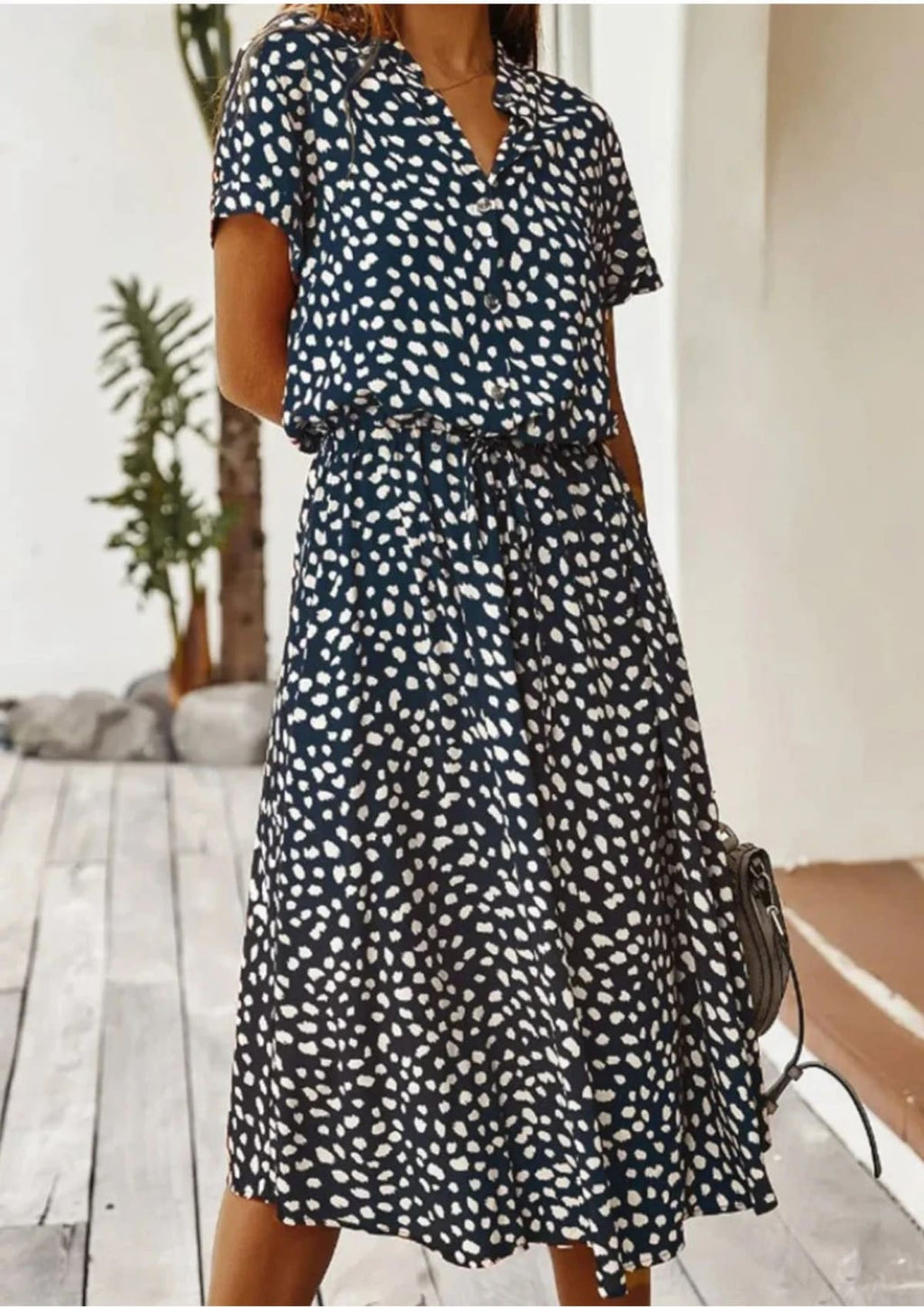 Spotted midi dress with button-down front and drawstring waist.