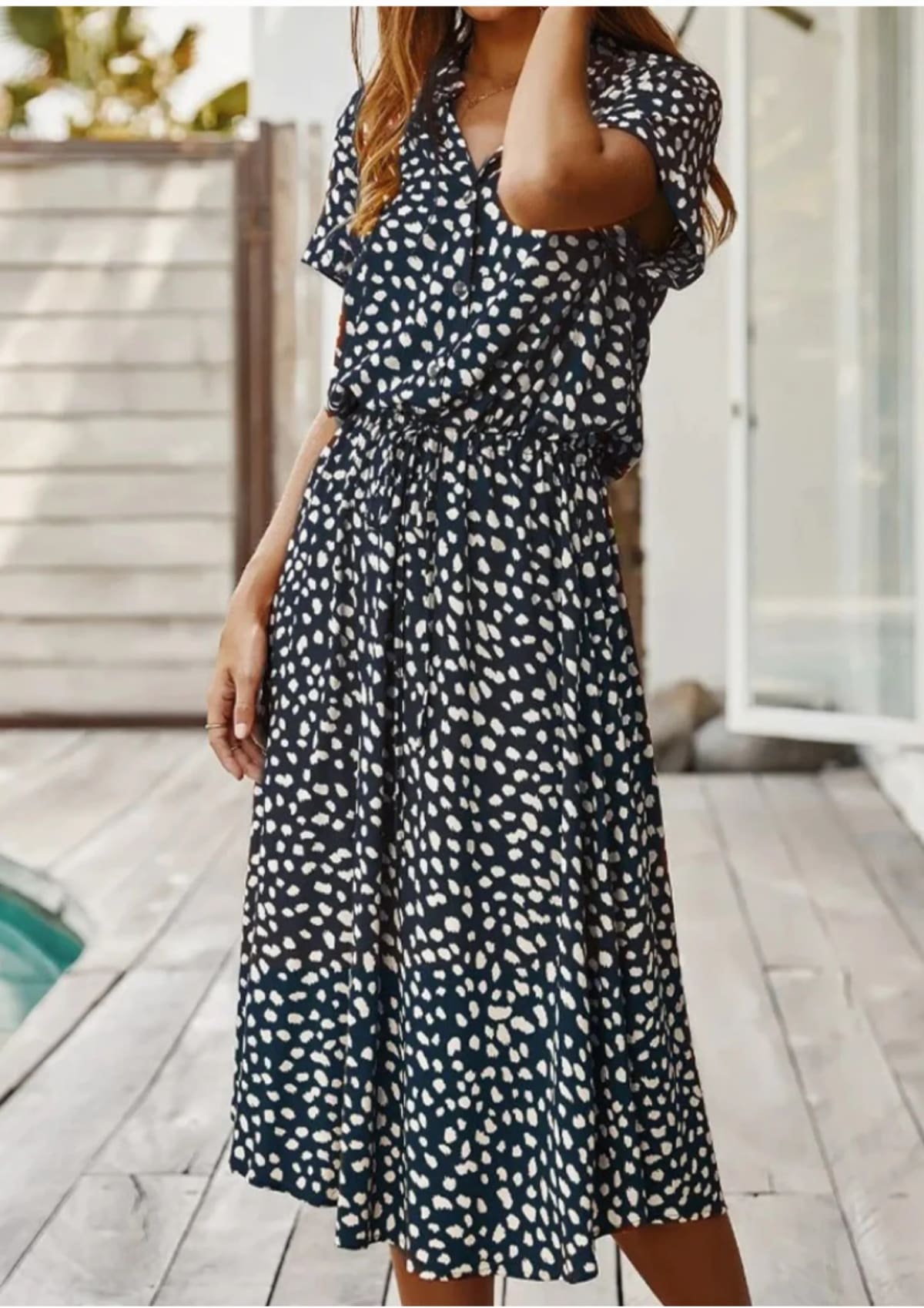 Spotted midi dress with button-down front and drawstring waist.