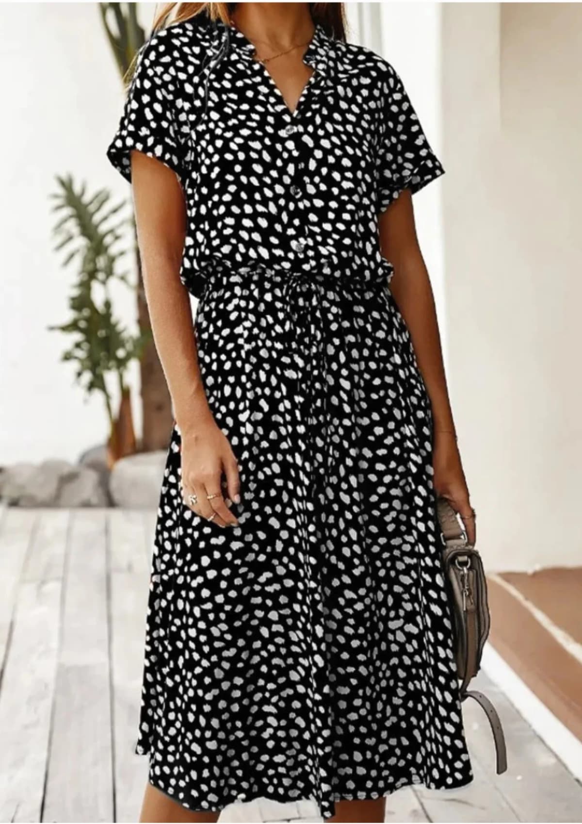 Spotted midi dress with button-down front and drawstring waist.
