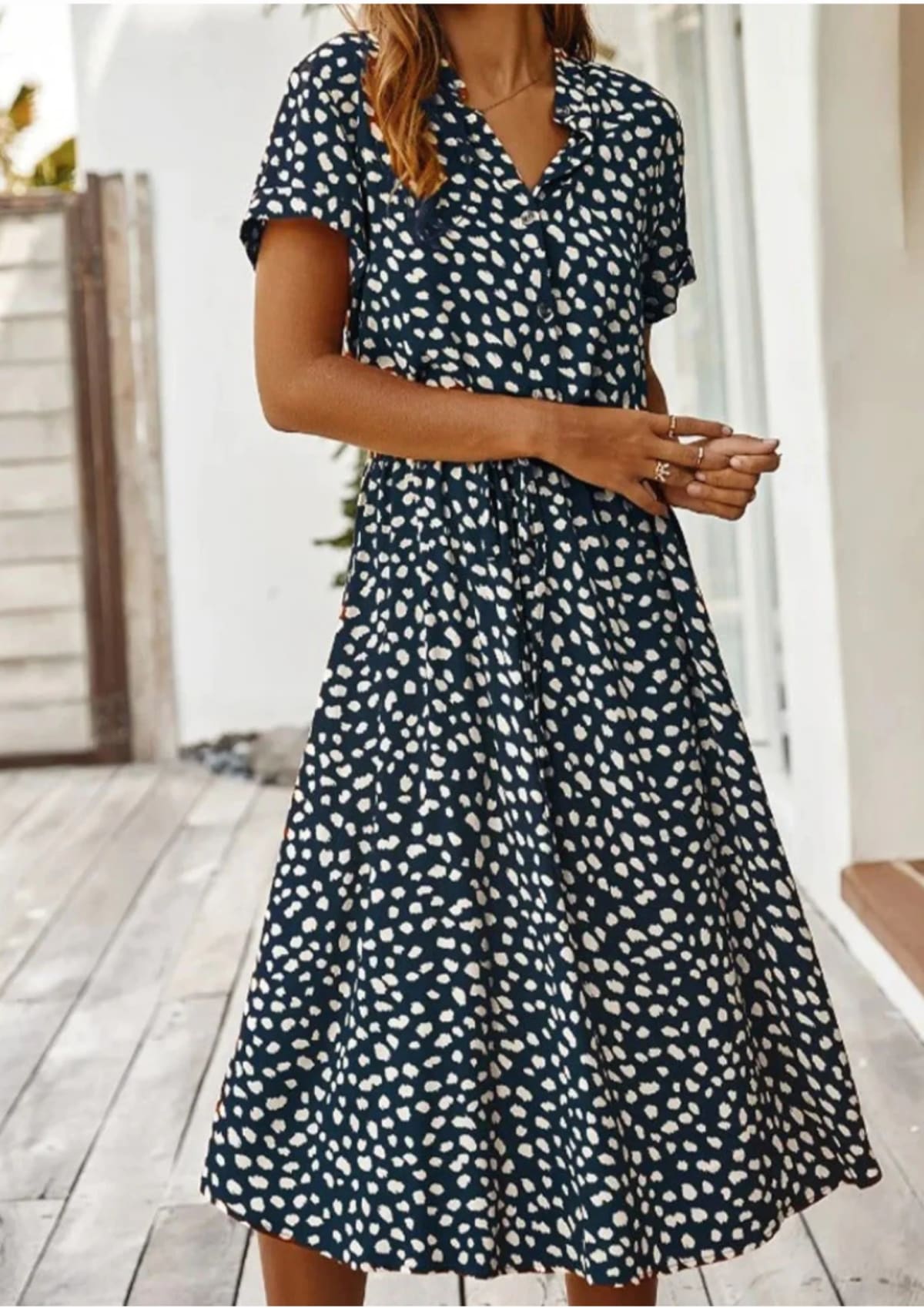 Spotted midi dress with button-down front and drawstring waist.