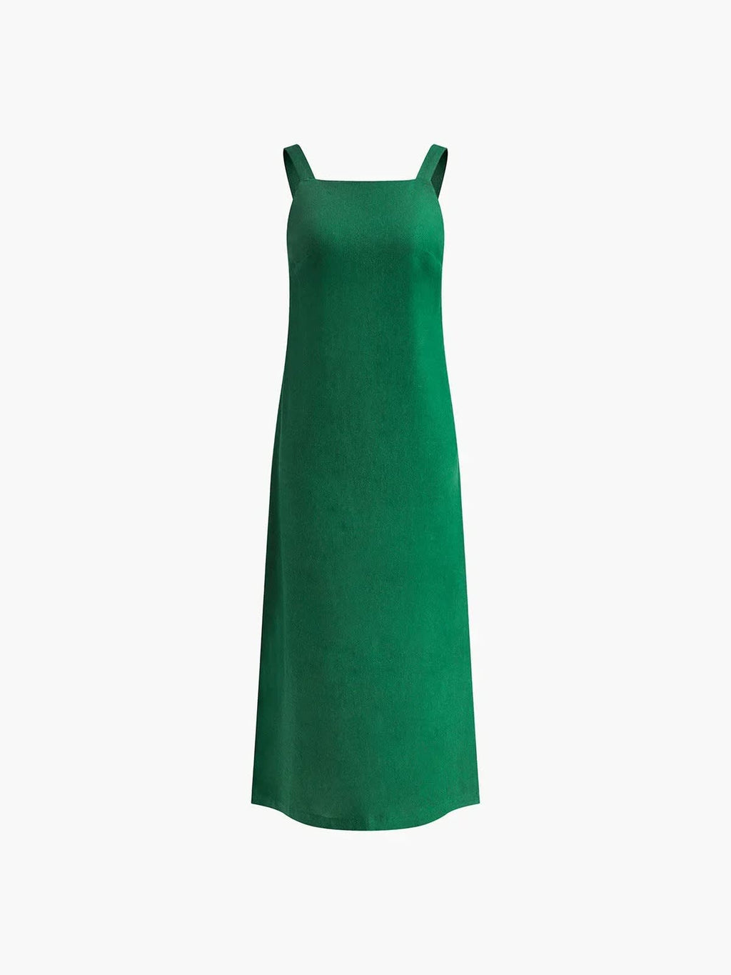 Woman in square neck midi dress with side slit against tiled wall.