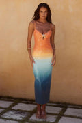 Woman wearing a strappy ombre sequin maxi dress with a starfish detail.