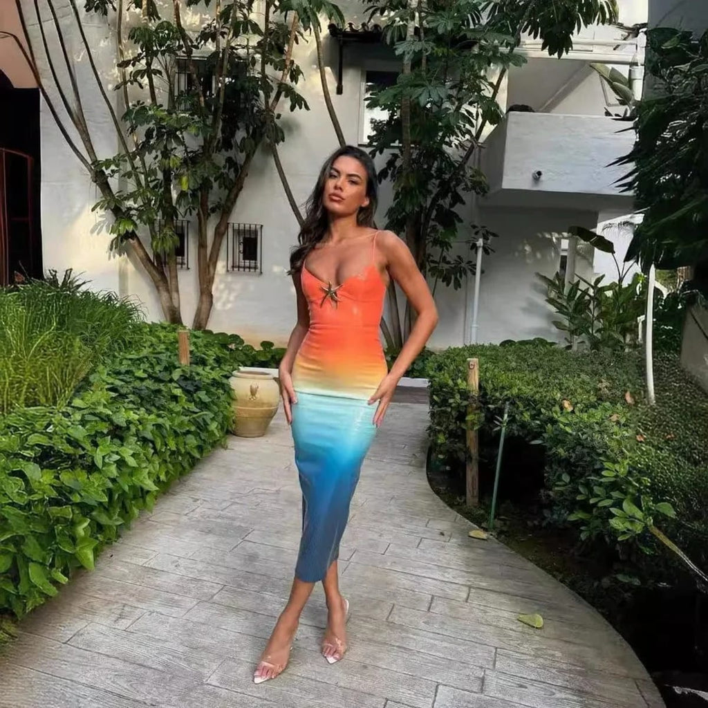 Woman wearing a strappy ombre sequin maxi dress with a starfish detail.