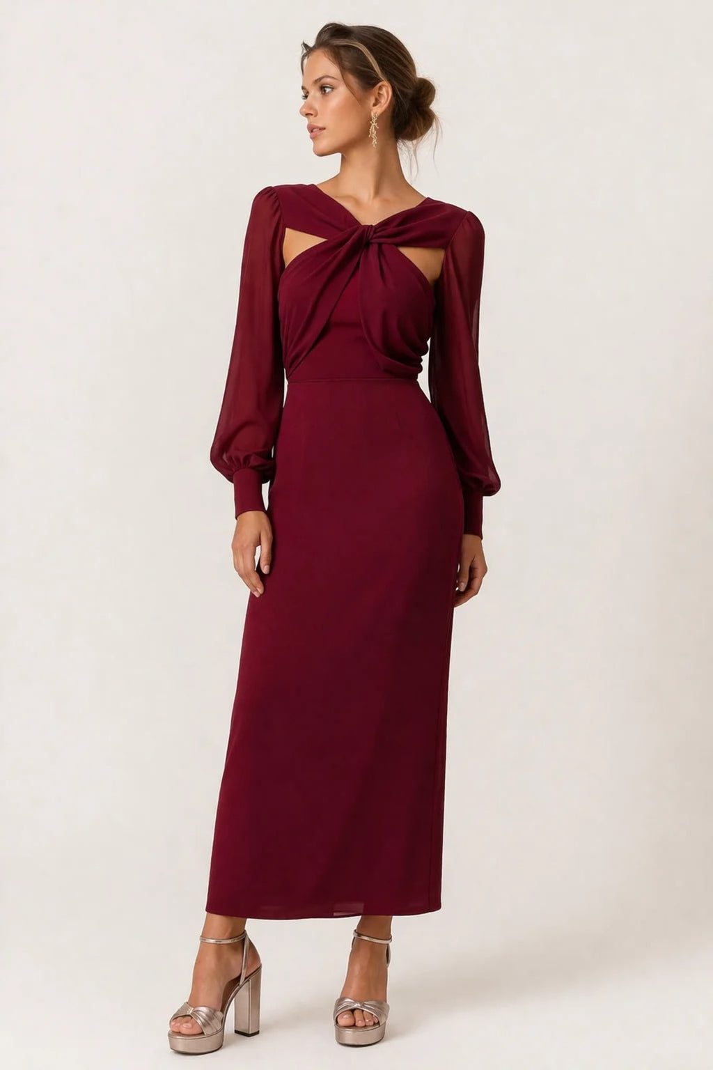Woman wearing a twist-front cut-out long-sleeve maxi dress.