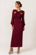 Woman wearing a twist-front cut-out long-sleeve maxi dress.