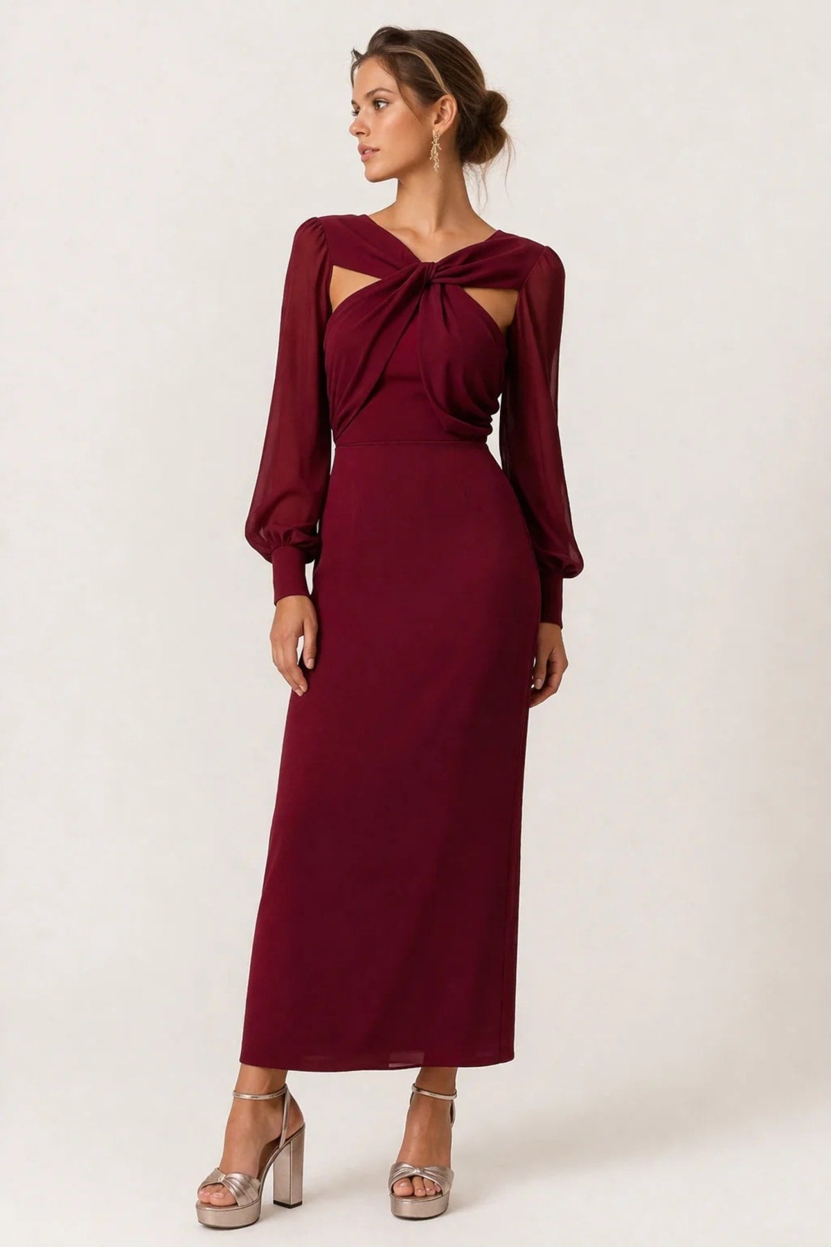 Woman wearing a twist-front cut-out long-sleeve maxi dress.