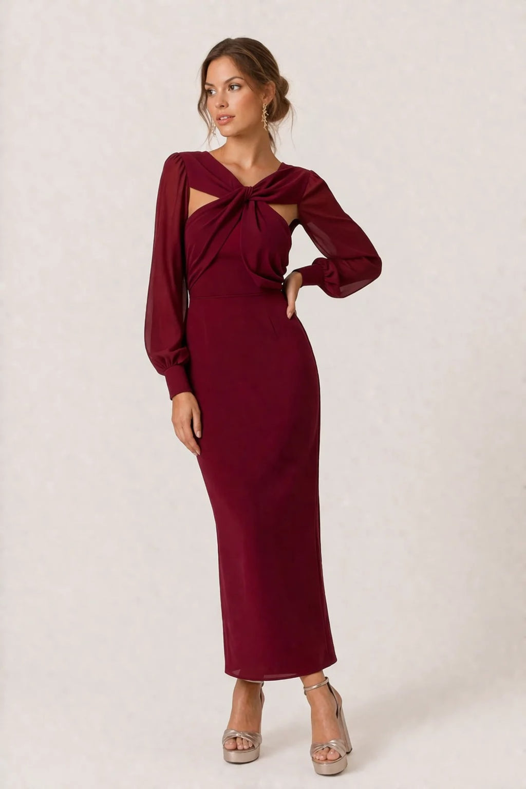 Woman wearing a twist-front cut-out long-sleeve maxi dress.