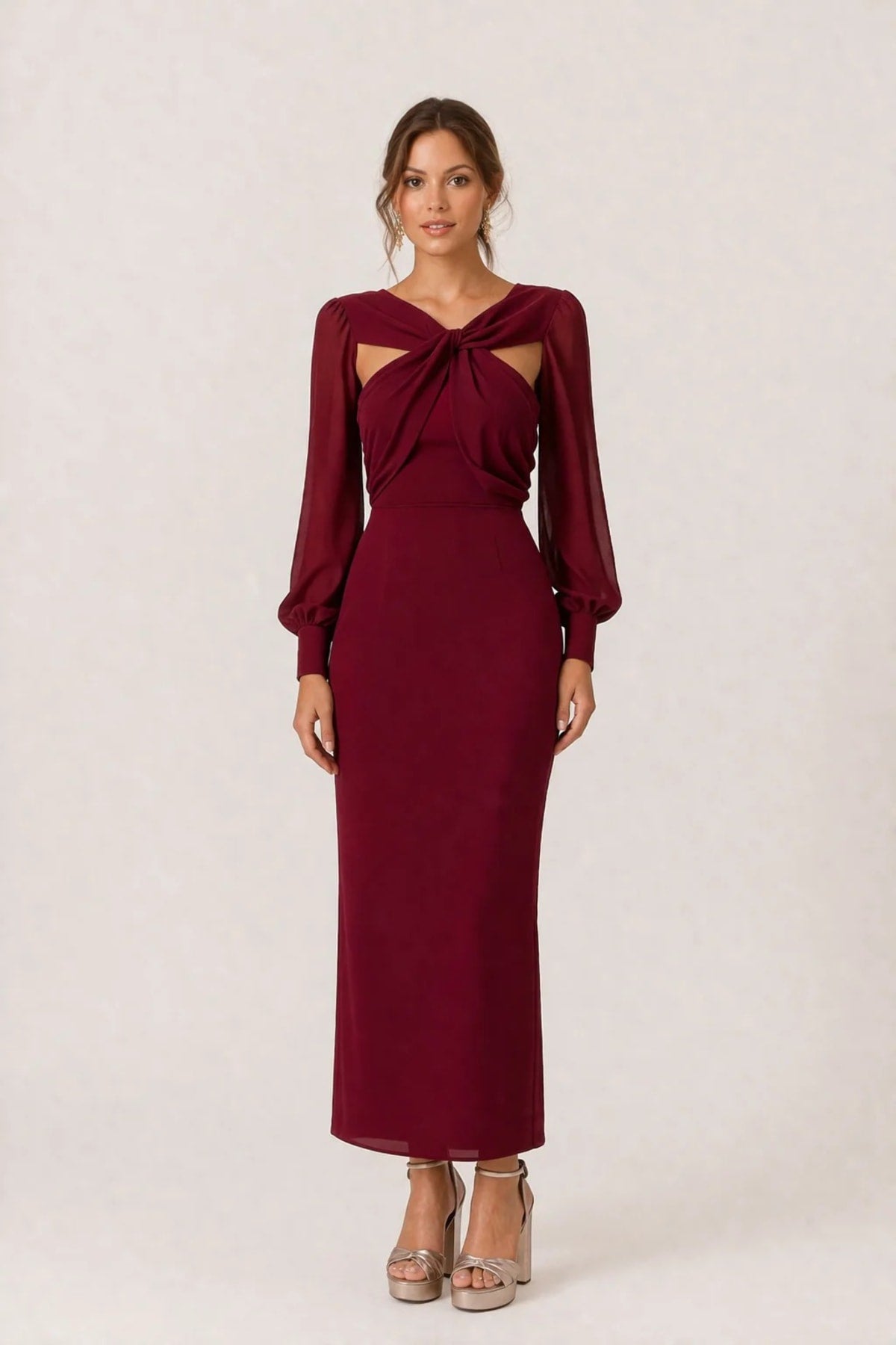 Woman wearing a twist-front cut-out long-sleeve maxi dress.