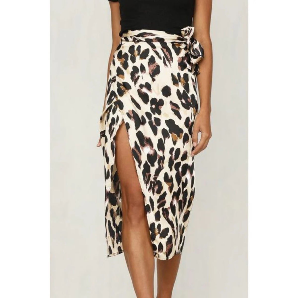 Close-up of a leopard print wrap midi skirt with a high slit.