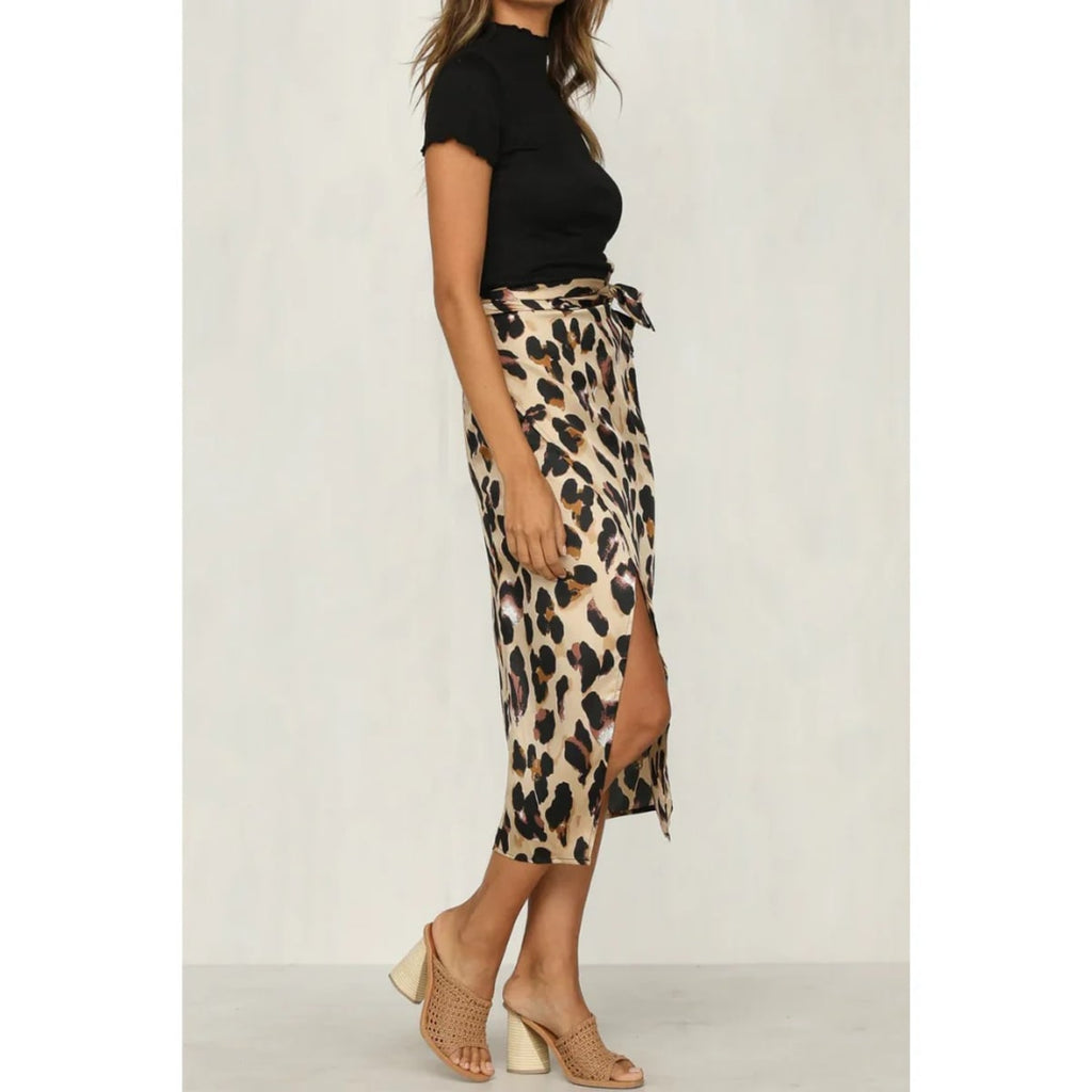 Close-up of a leopard print wrap midi skirt with a high slit.