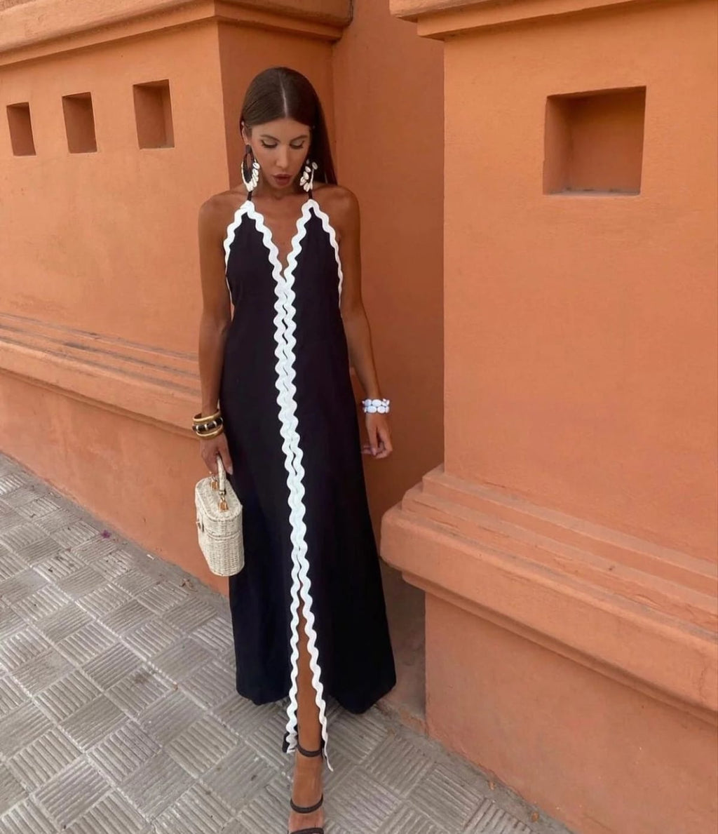 Full-length wrap dress with smooth fabric and structured neckline.