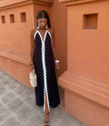 Full-length wrap dress with smooth fabric and structured neckline.