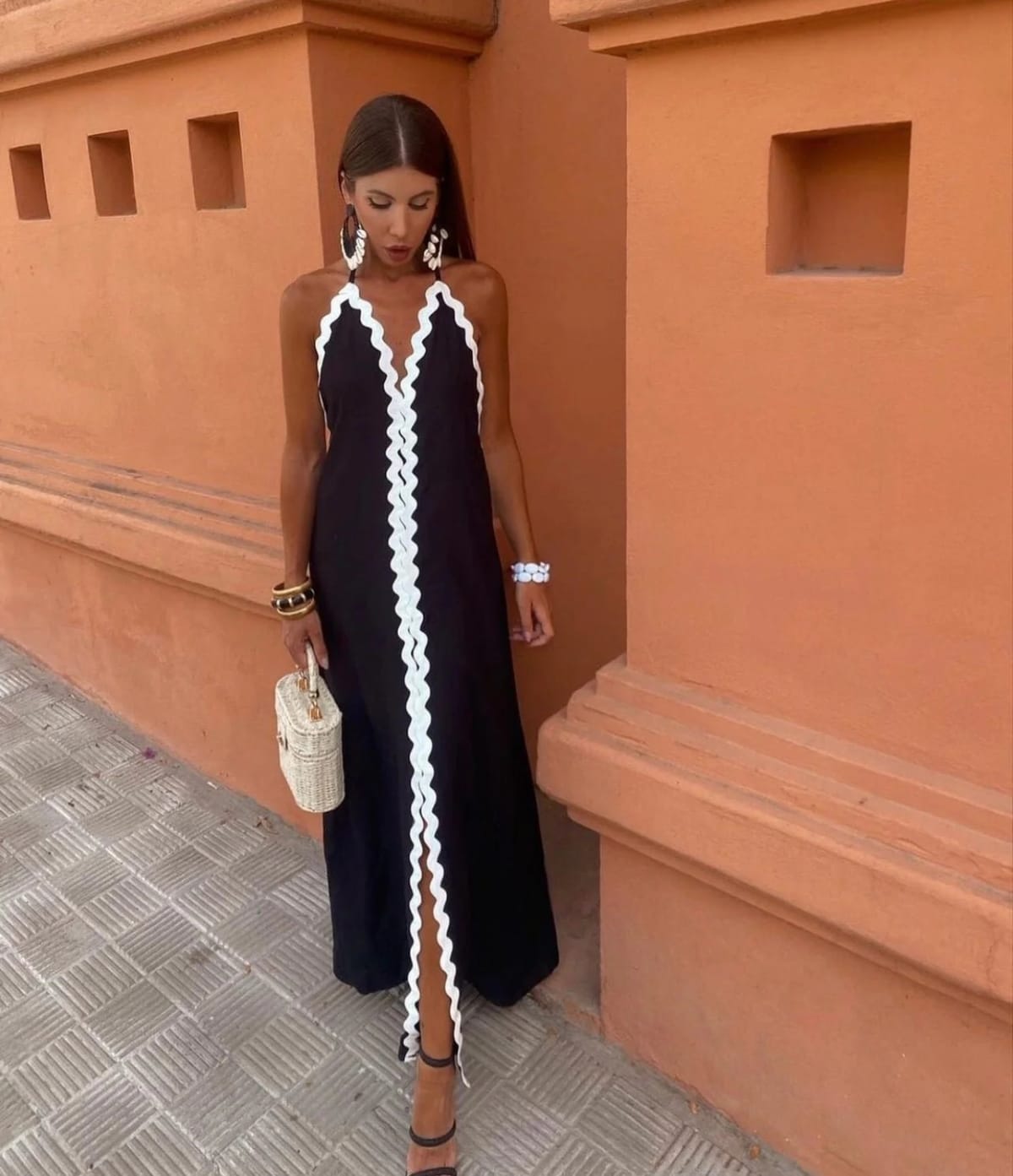 Full-length wrap dress with smooth fabric and structured neckline.
