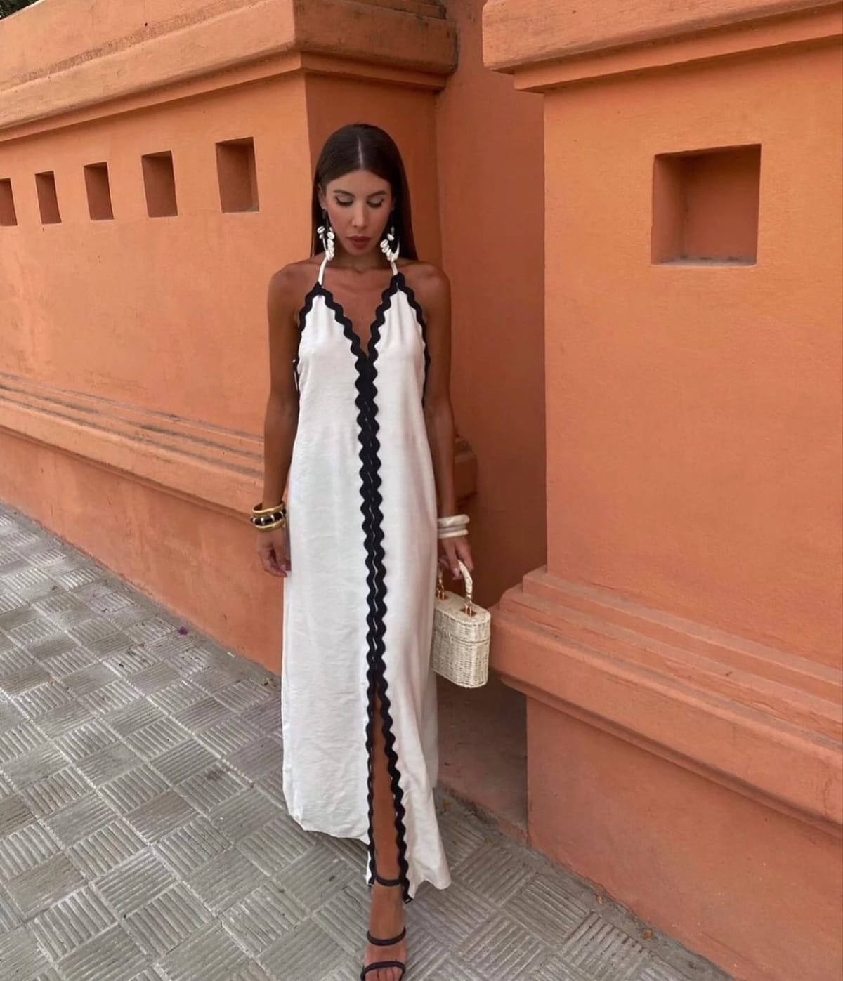 Full-length wrap dress with smooth fabric and structured neckline.