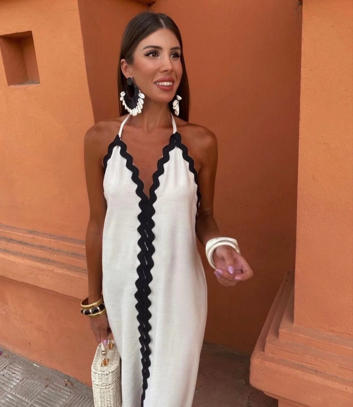 Full-length wrap dress with smooth fabric and structured neckline.