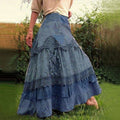 Person wearing a tiered maxi skirt with lace panels.