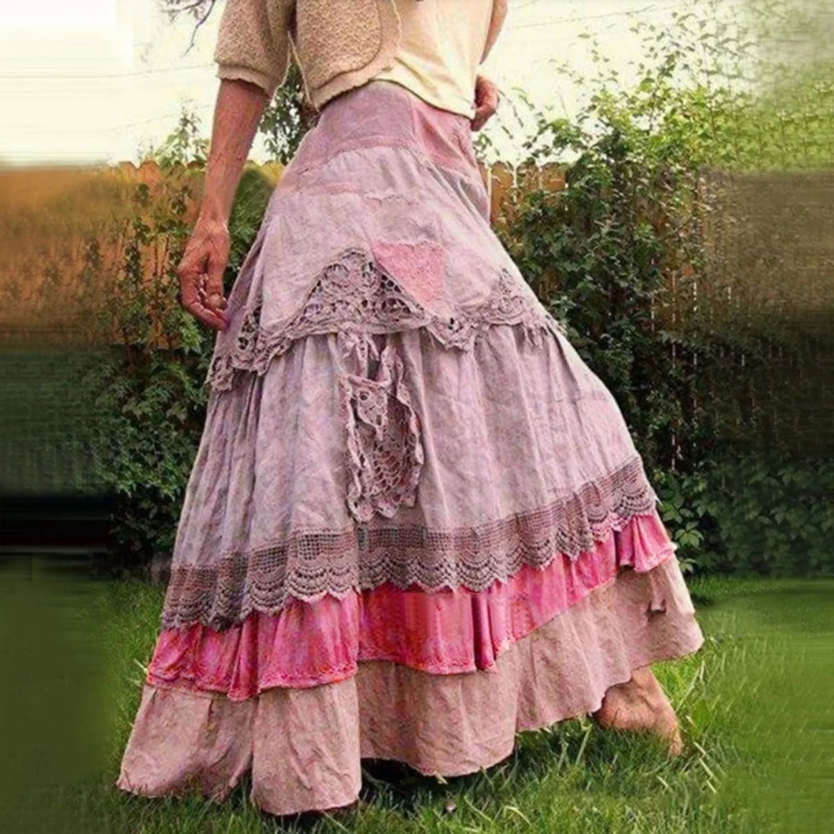 Person wearing a tiered maxi skirt with lace panels.