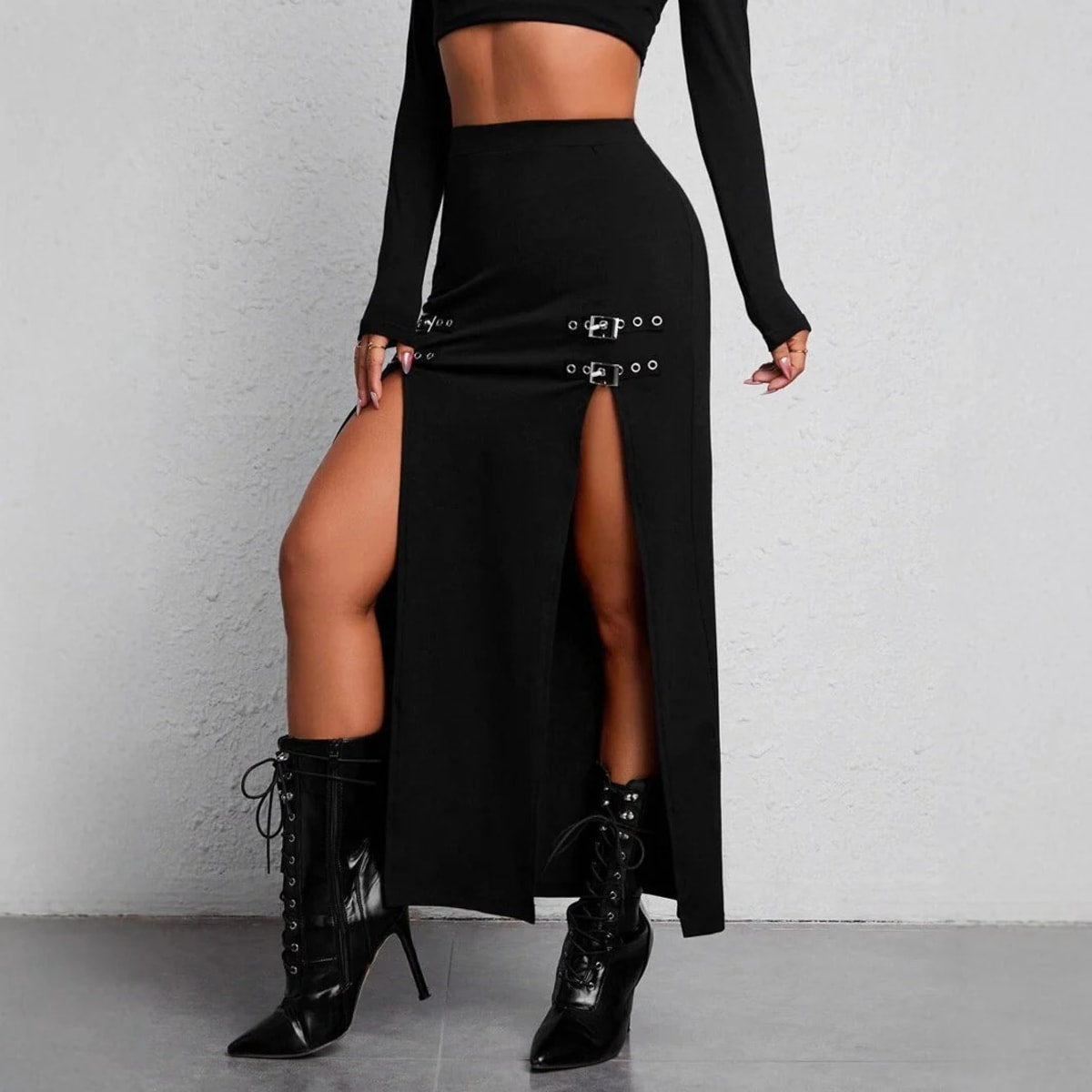 Woman wearing high-waisted maxi skirt with slits and buckle details.