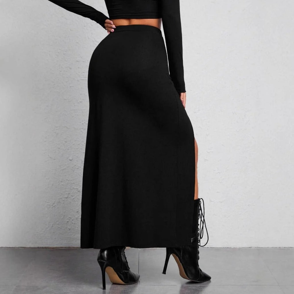 Woman wearing high-waisted maxi skirt with slits and buckle details.
