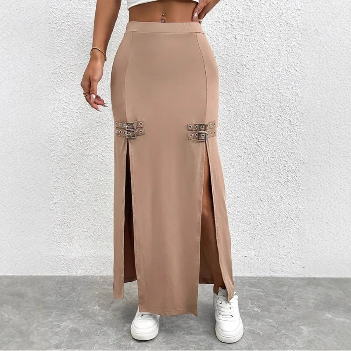 Woman wearing high-waisted maxi skirt with slits and buckle details.