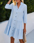 Relaxed check dress with button front and tiered skirt.