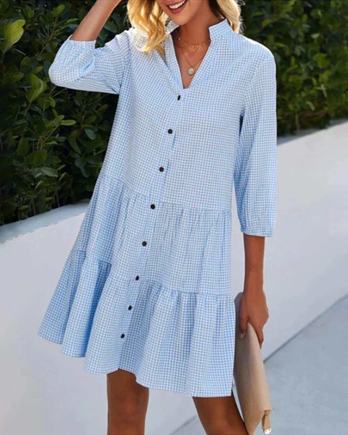 Relaxed check dress with button front and tiered skirt.