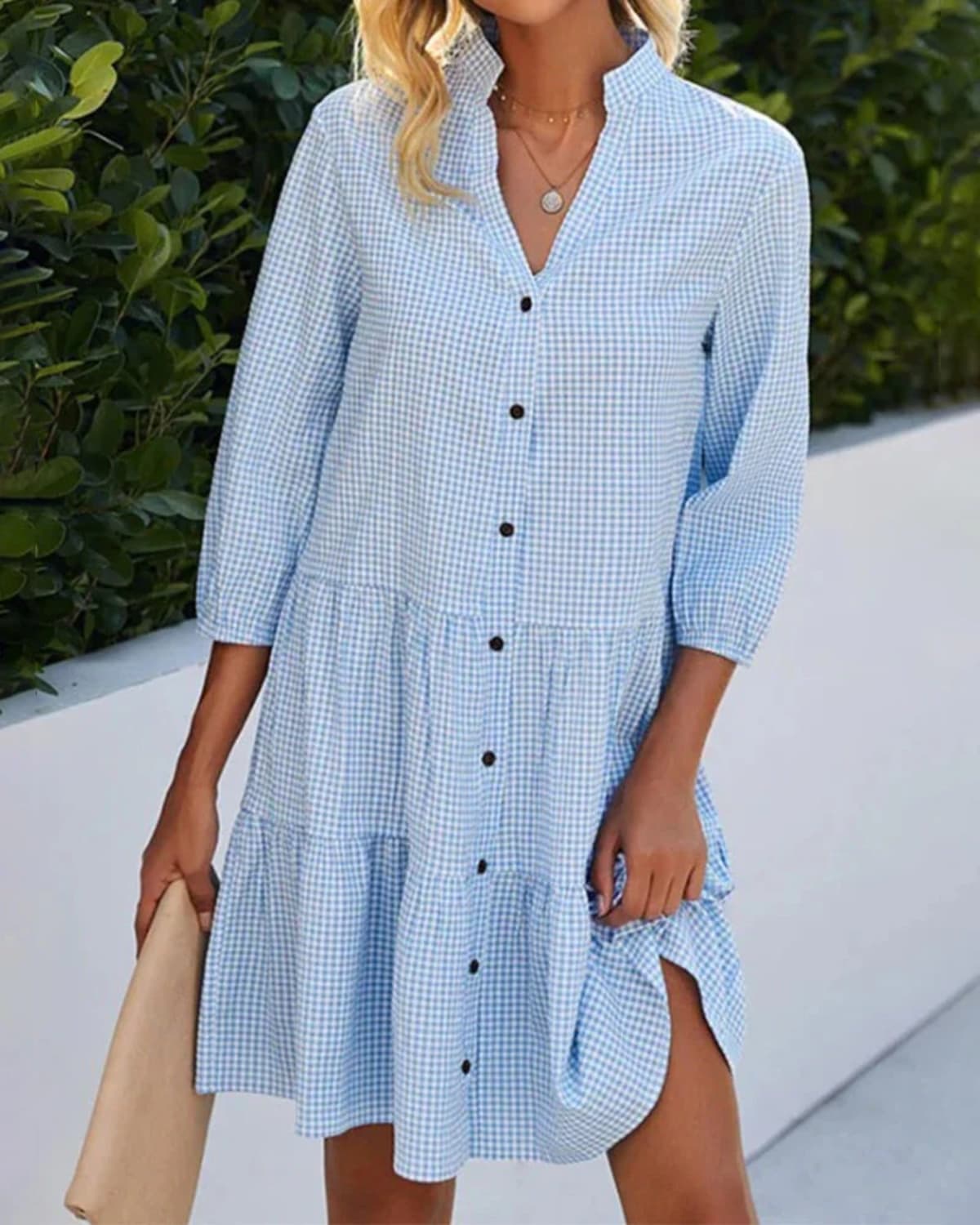 Relaxed check dress with button front and tiered skirt.