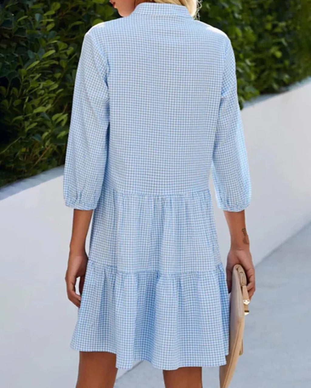 Relaxed check dress with button front and tiered skirt.
