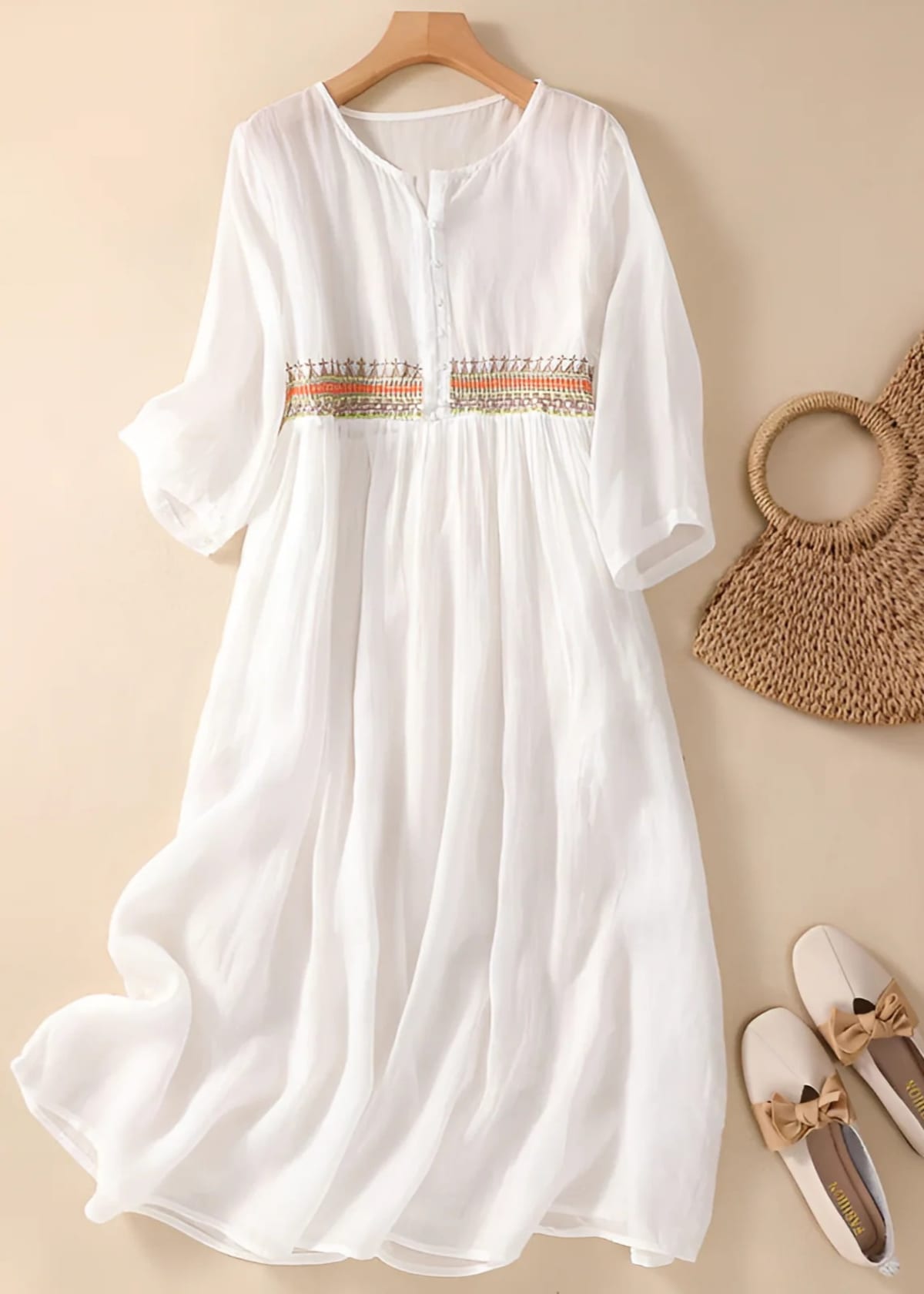 Embroidered midi dress with relaxed silhouette and flowing fit.