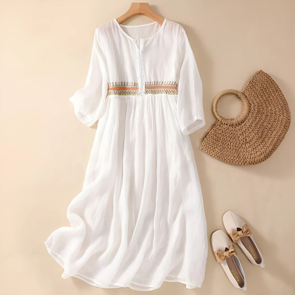 Embroidered midi dress with relaxed silhouette and flowing fit.