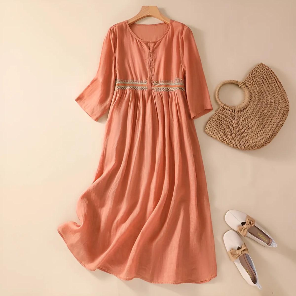 Embroidered midi dress with relaxed silhouette and flowing fit.