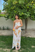 Flowing halter neck maxi dress with empire waist and layered design.