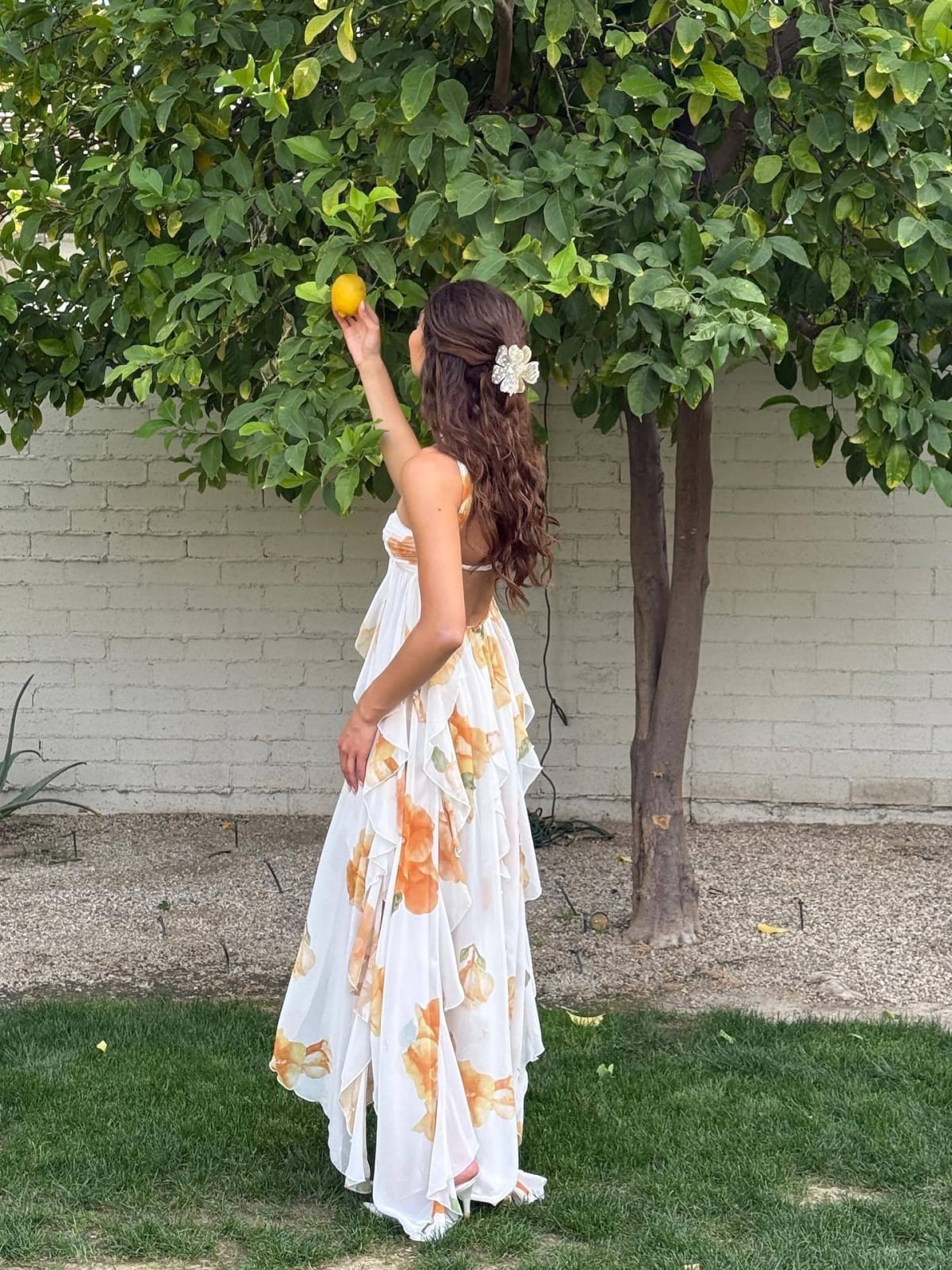 Flowing halter neck maxi dress with empire waist and layered design.