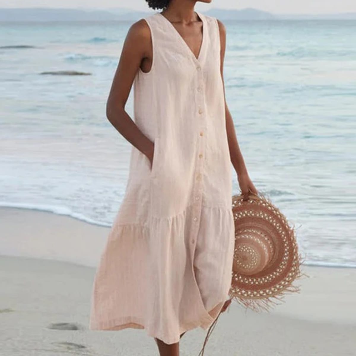 Sleeveless midi dress with front buttons on mannequin.