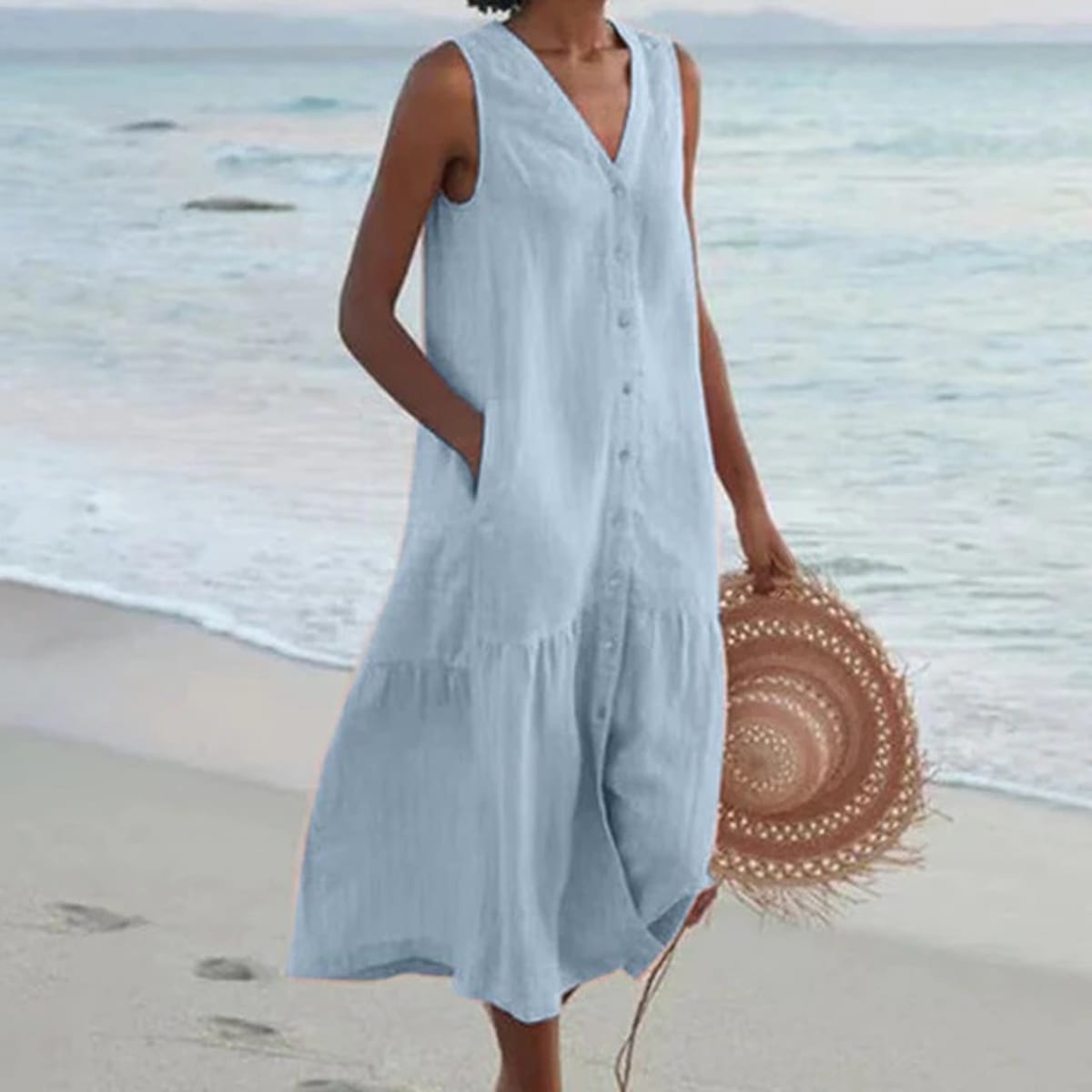 Sleeveless midi dress with front buttons on mannequin.