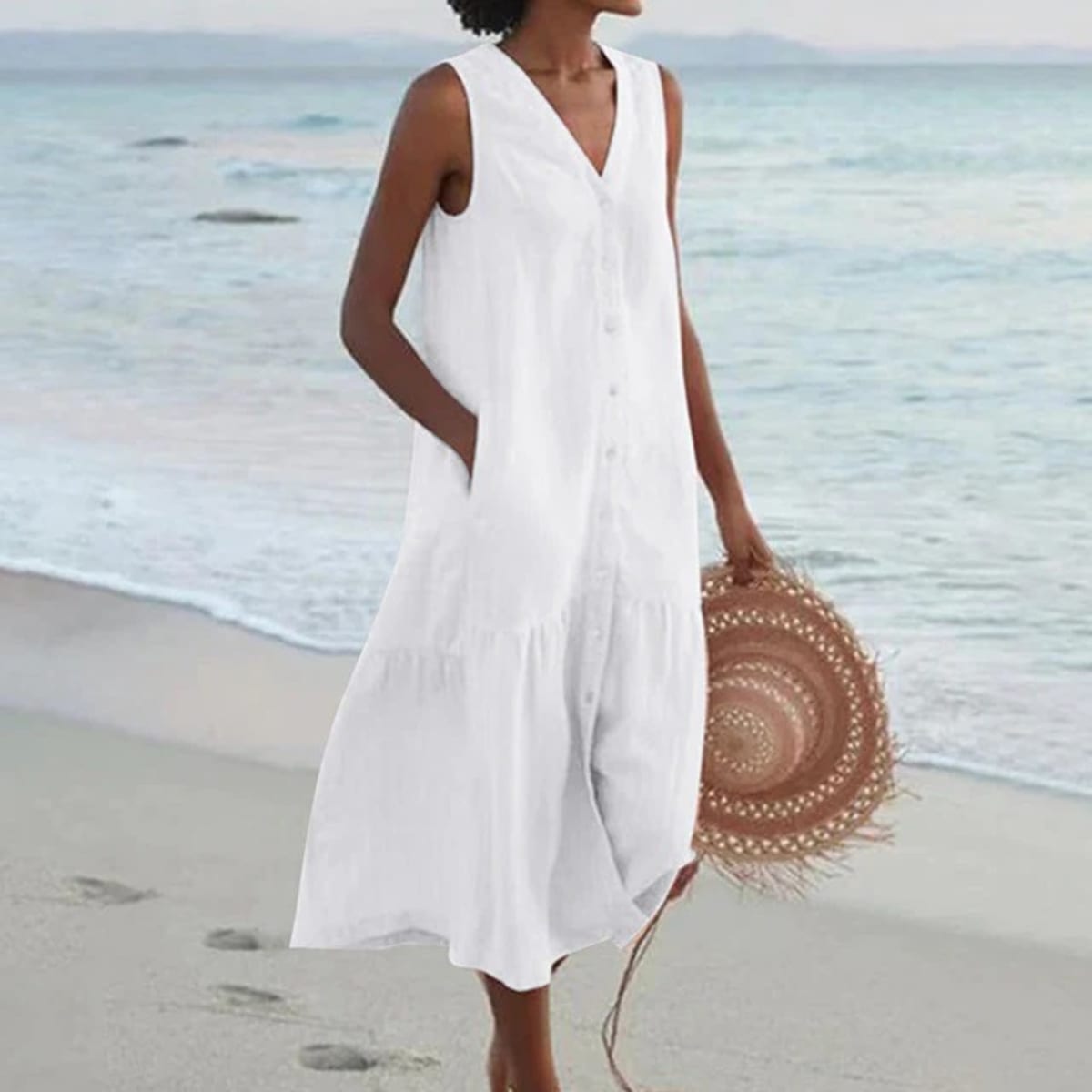 Sleeveless midi dress with front buttons on mannequin.