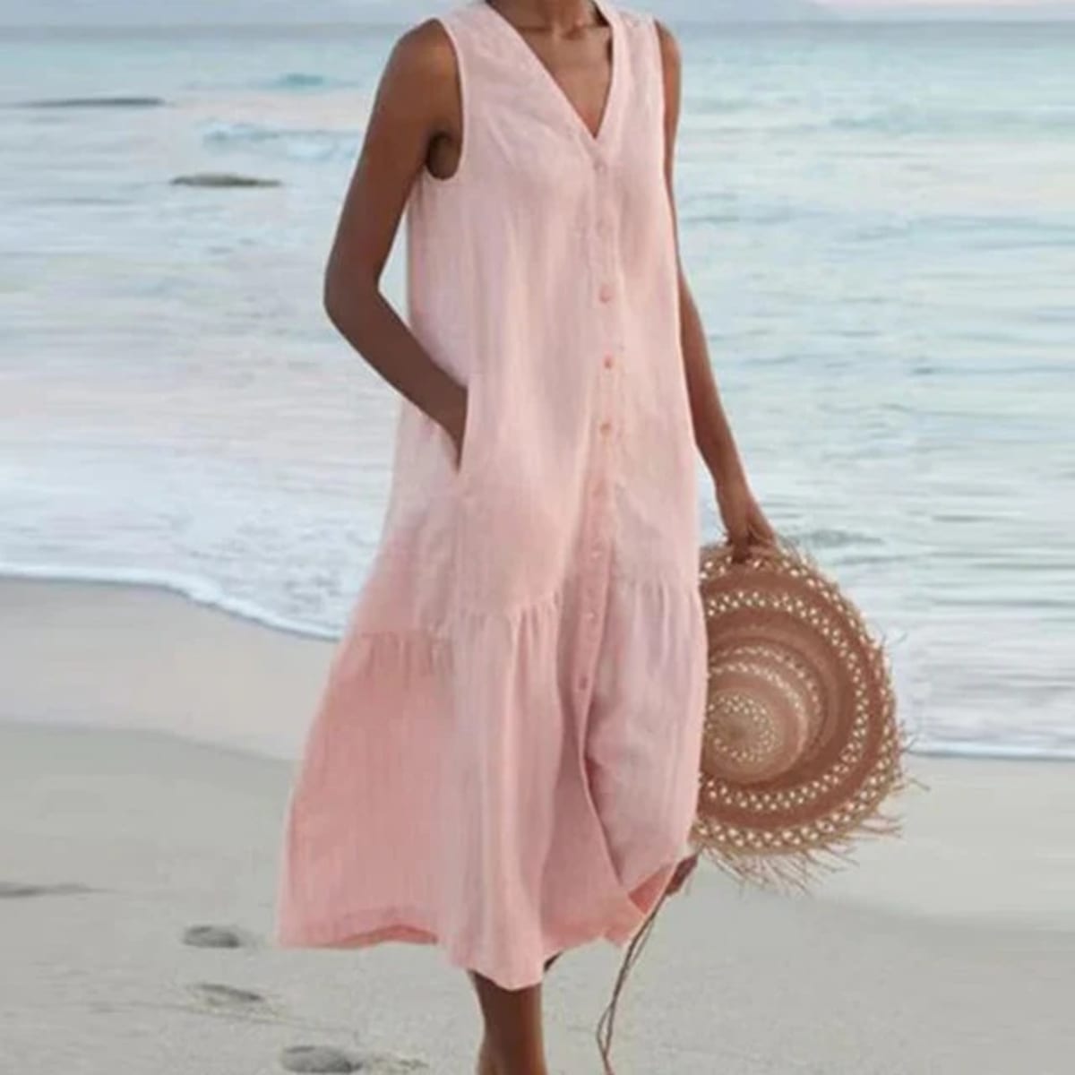 Sleeveless midi dress with front buttons on mannequin.