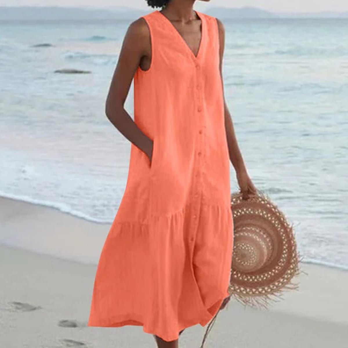 Sleeveless midi dress with front buttons on mannequin.