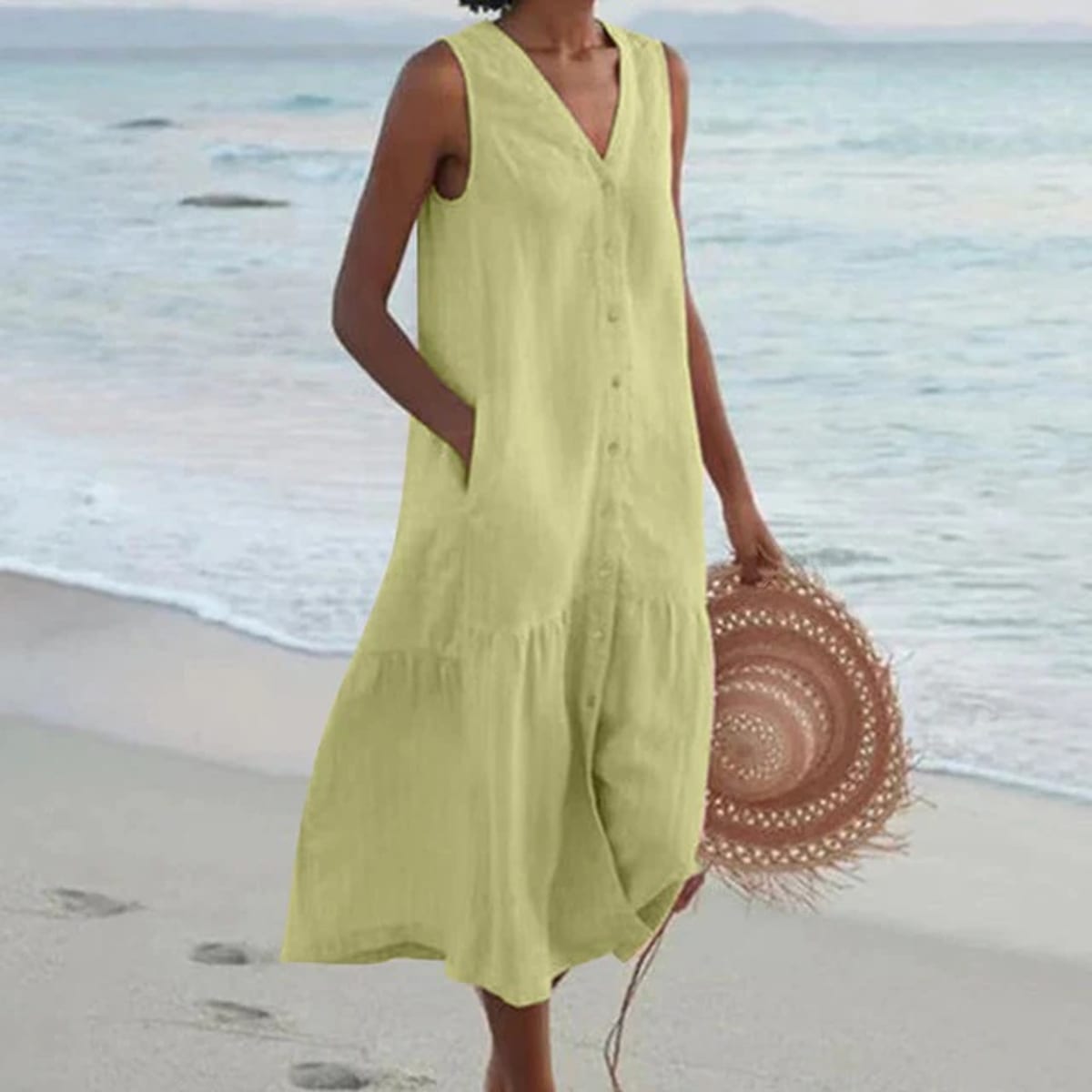 Sleeveless midi dress with front buttons on mannequin.