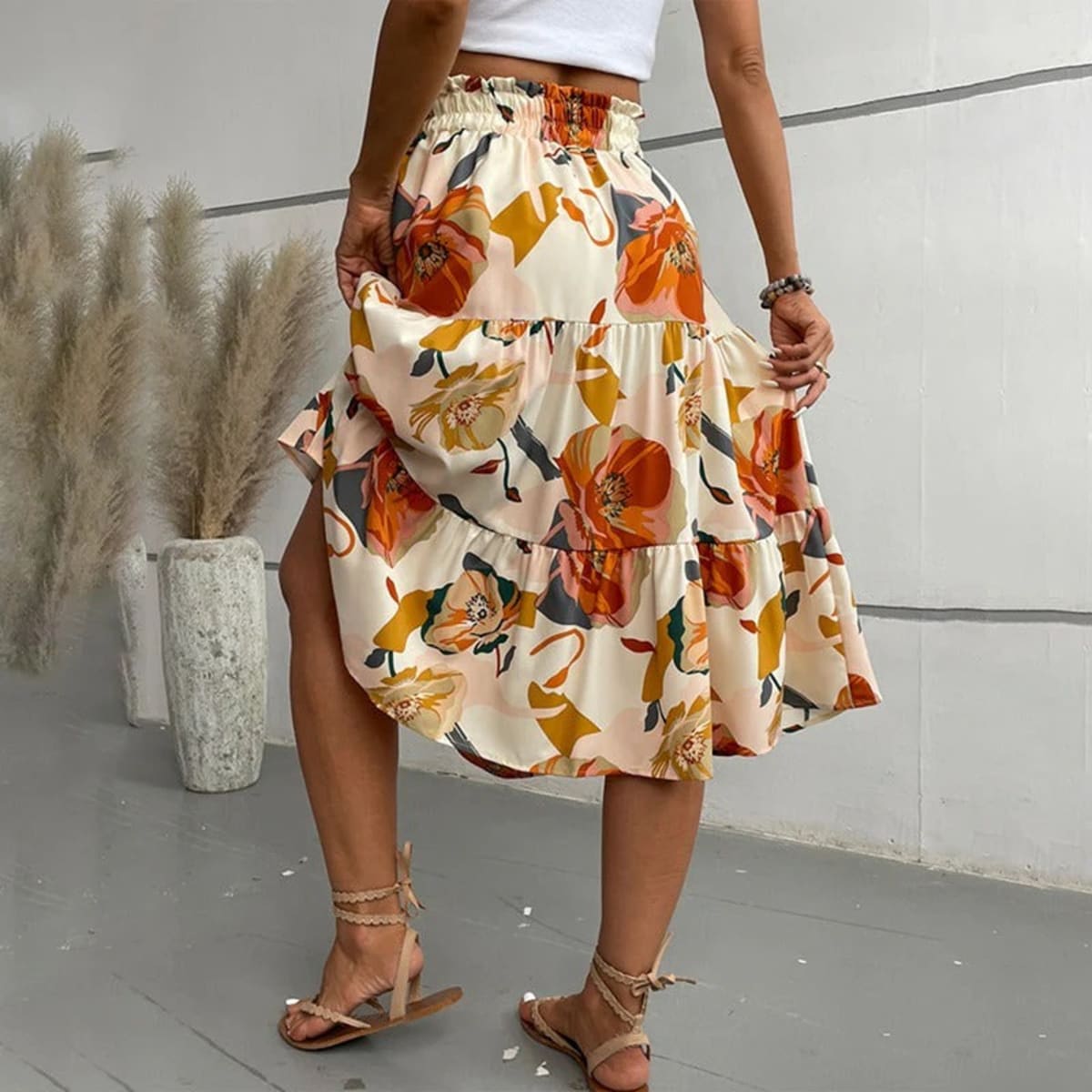 Tiered maxi skirt with vibrant floral print and elastic waist.