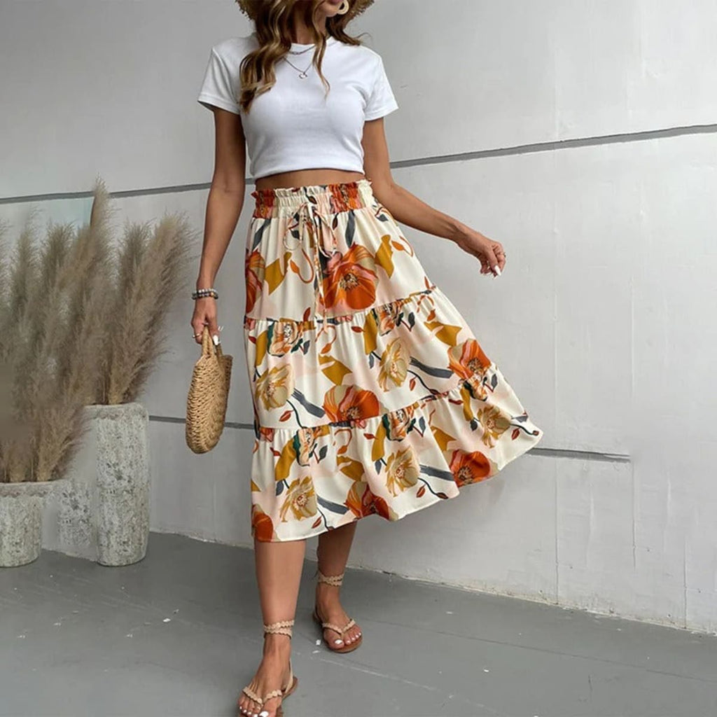 Tiered maxi skirt with vibrant floral print and elastic waist.