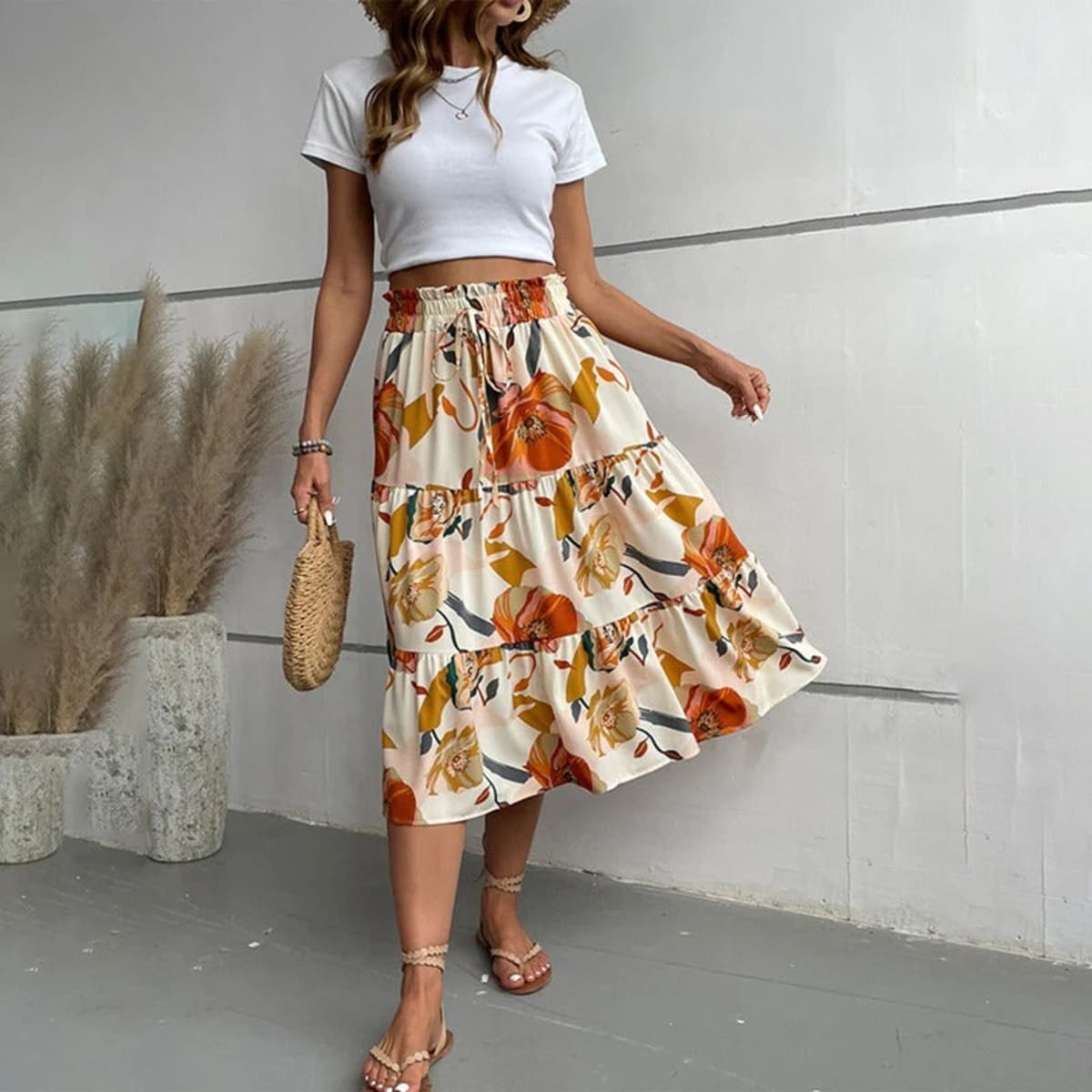 Tiered maxi skirt with vibrant floral print and elastic waist.
