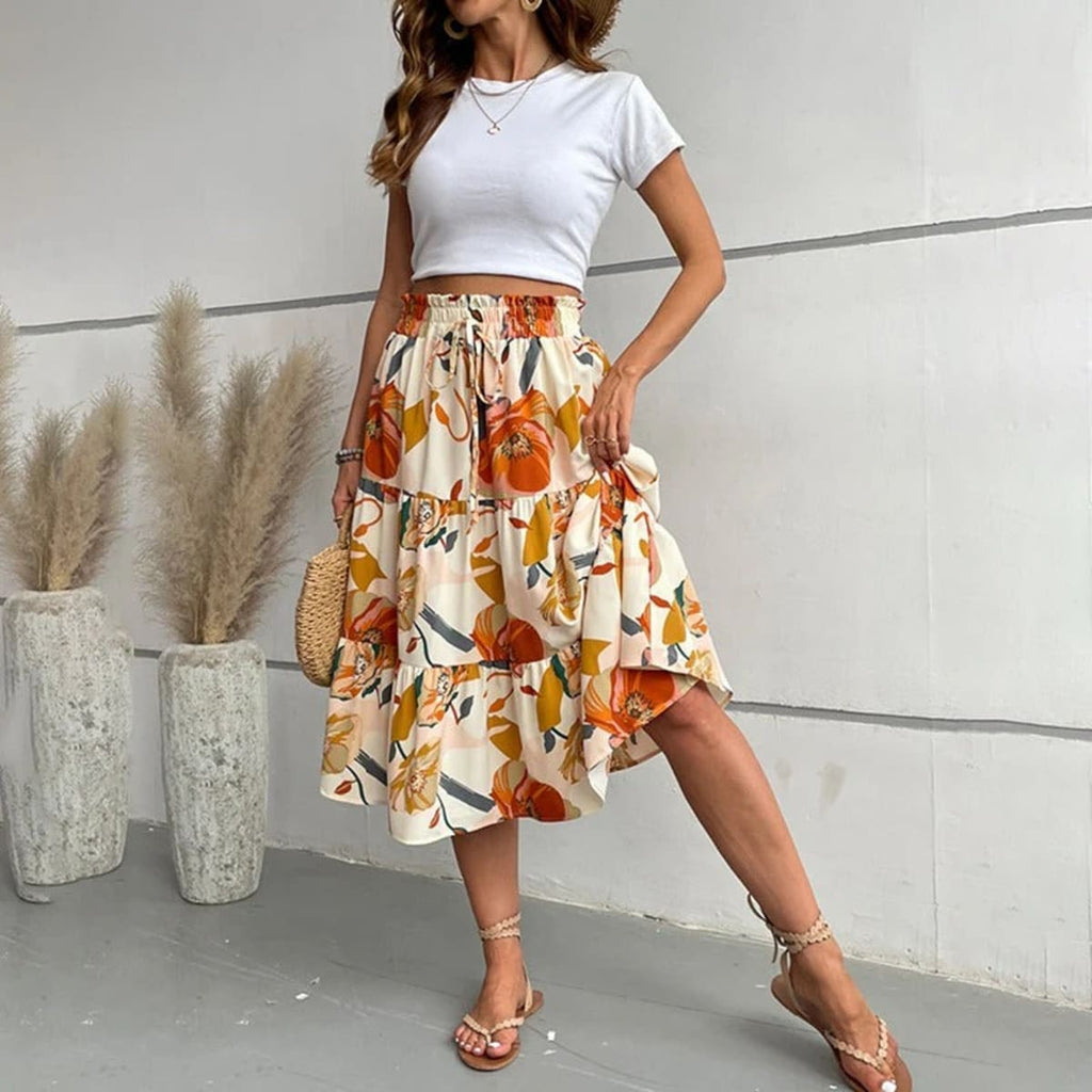 Tiered maxi skirt with vibrant floral print and elastic waist.