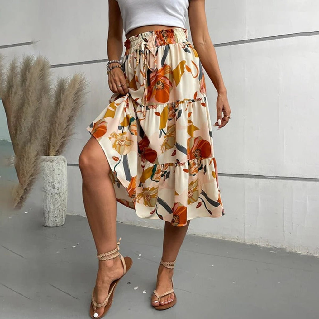 Tiered maxi skirt with vibrant floral print and elastic waist.