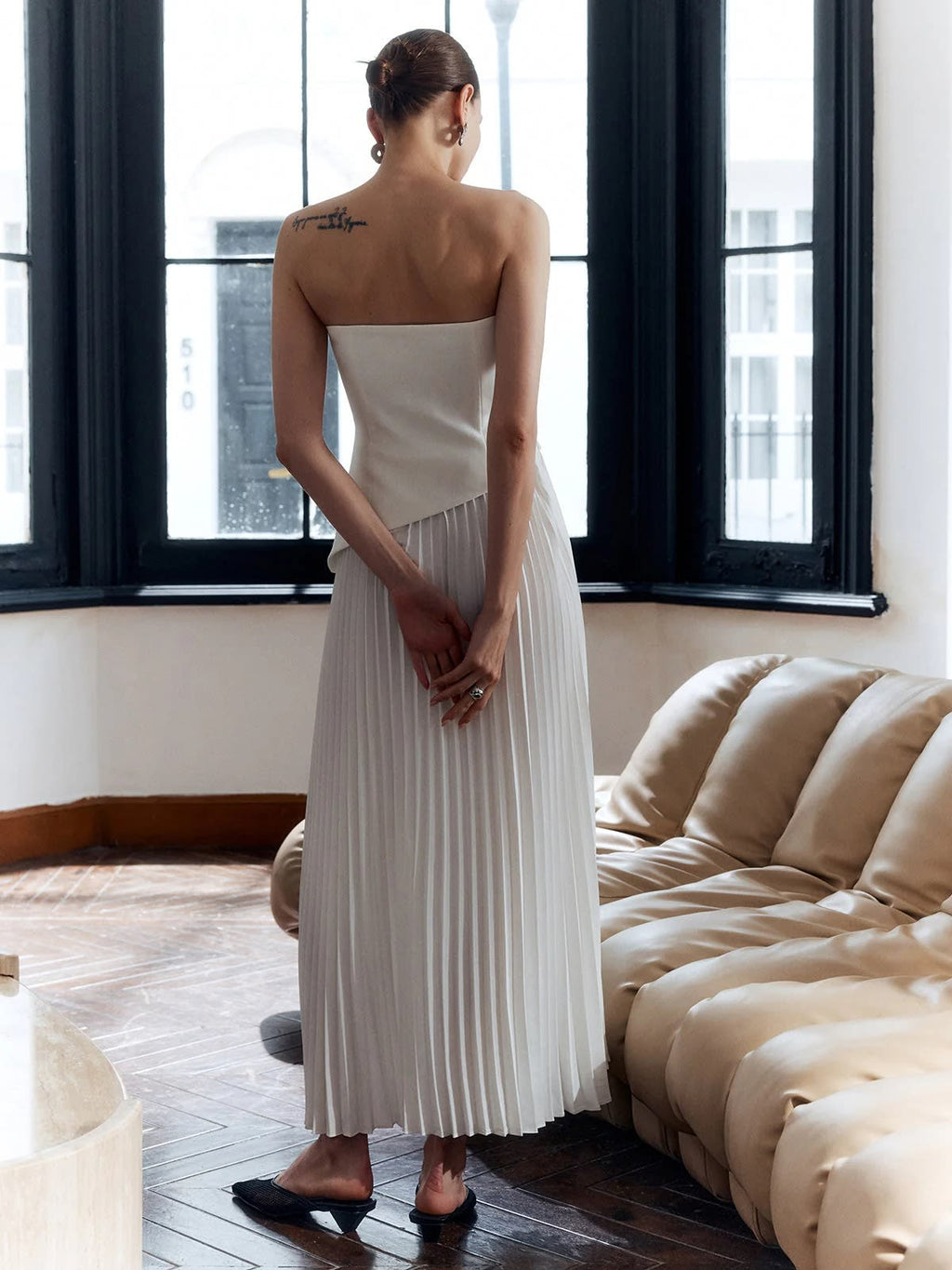 Strapless pleated maxi dress with side split and bandeau bodice.